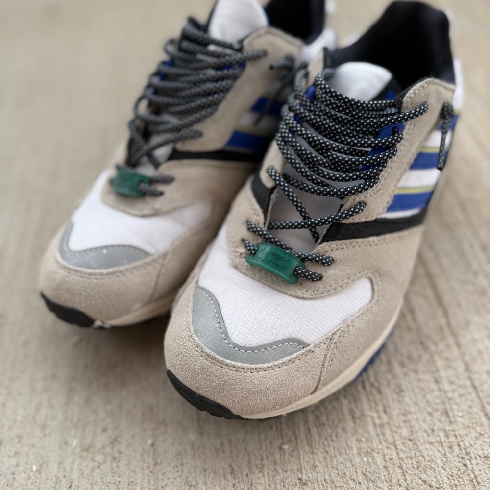 Stylish Beige and White Sneakers with Blue Accents